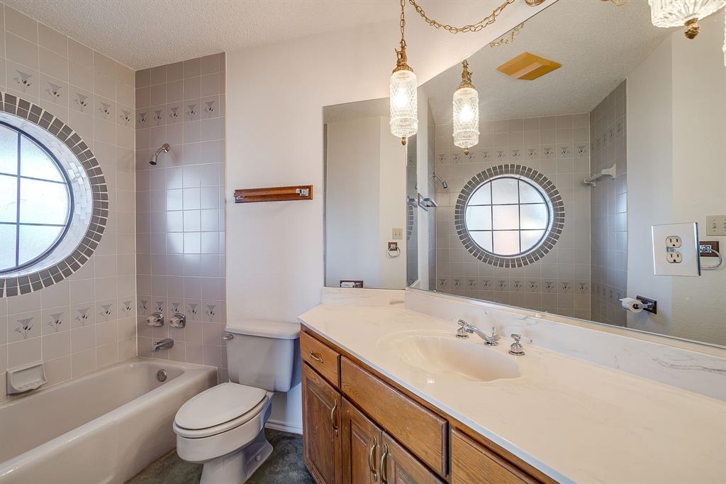 3017 Freeman Lane Crowley, TX 76036 - Photo 34 of 39 a bathroom with a toilet a sink a mirror and a bathtub