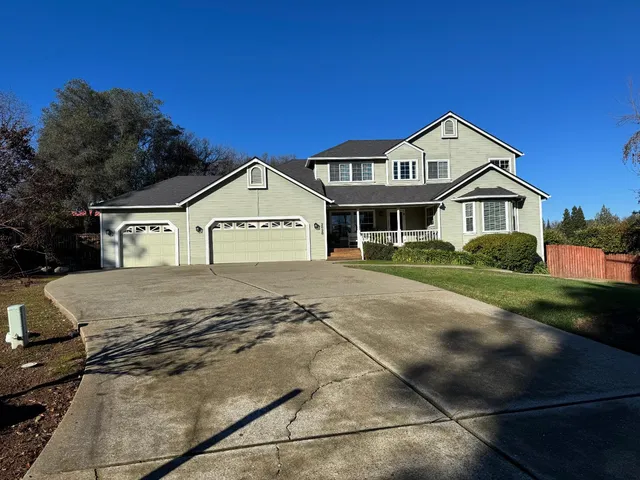 a view of a house with a yard patio and swimming pool