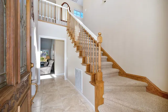 a view of a dining room with furniture and a potted plant
