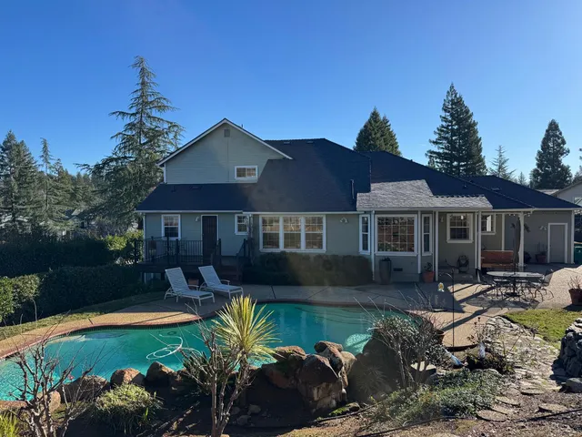 a view of a house with a small yard and plants