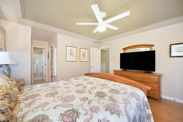 a living room with furniture a flat screen tv and a large window