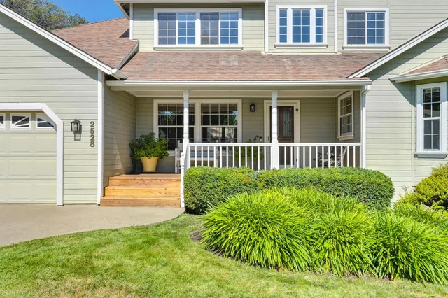 a front view of a house with a garden