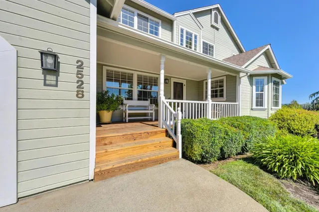 a living room with furniture a flat screen tv and a large window