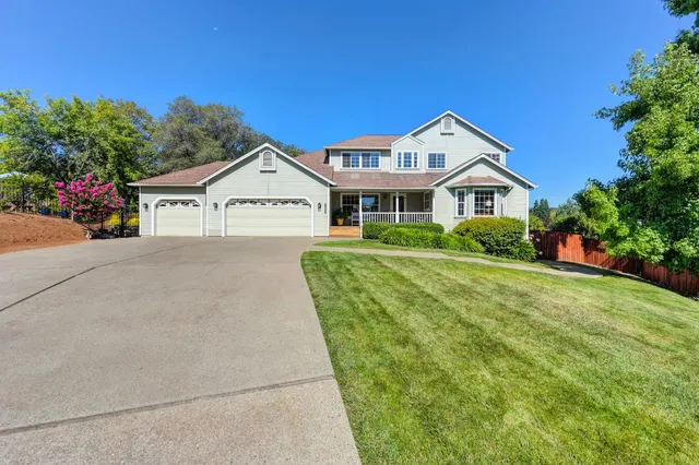 a front view of a house with potted plants