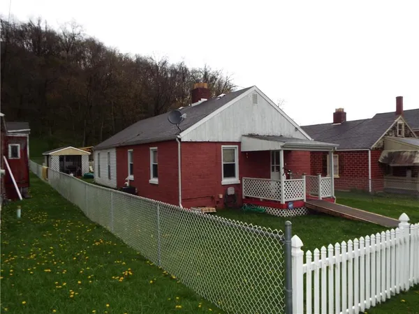 a front view of a house with a yard table and chairs