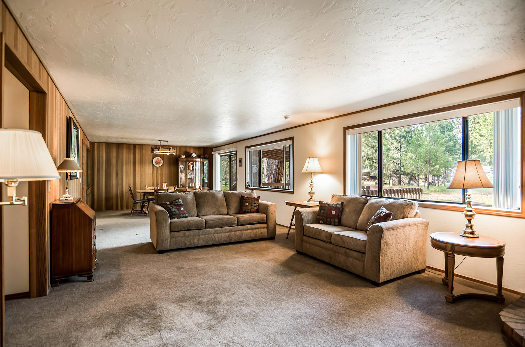 14557 Crossroads Loop Sisters, OR 97759 - Photo 14 of 25 Living room with clear cedar, large bright windows. Newer carpet and paint in this room