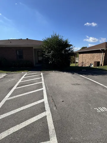 a view of a car park both side of house