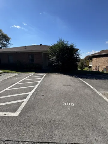 a kitchen with a sink a refrigerator and cabinets