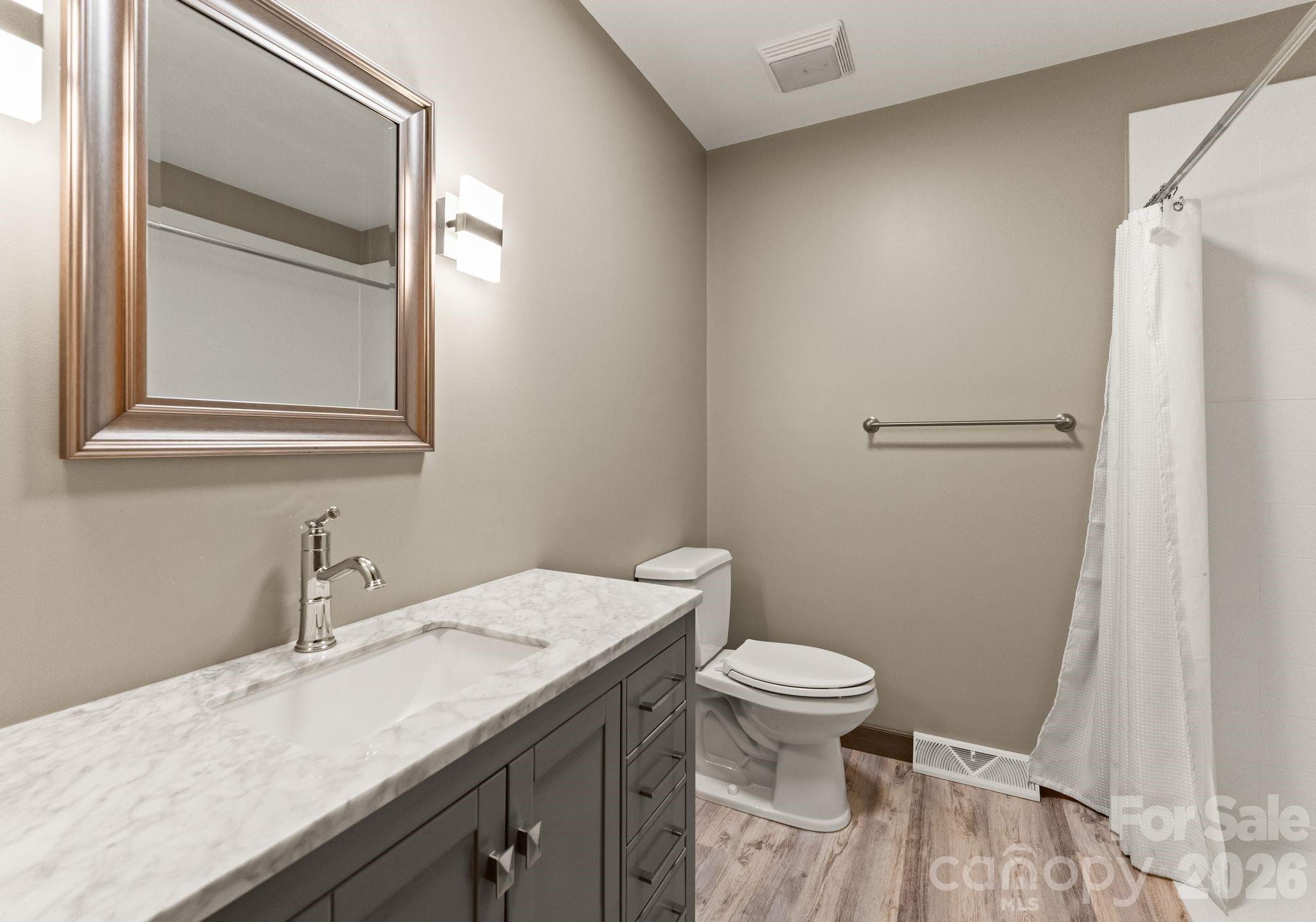 150 Barber Lyerly Road Salisbury, NC 28147 - Photo 16 of 43 a bathroom with a granite countertop sink toilet and a mirror