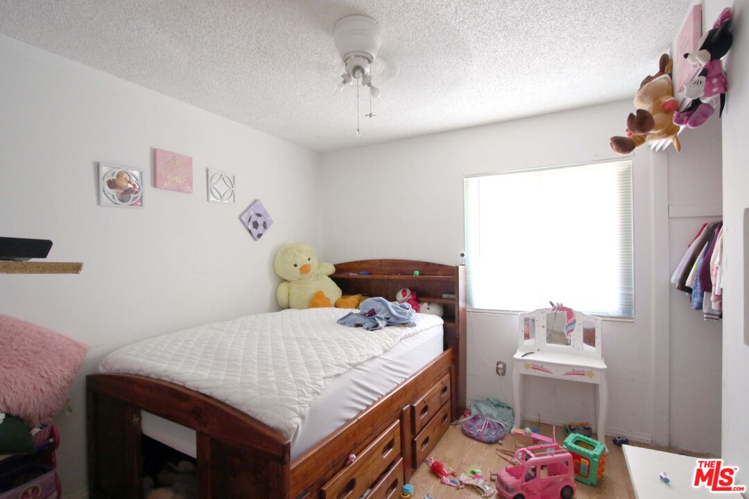 8820 Holly Lane Riverside, CA 92503 - Photo 2 of 20 a bedroom with a bed and a chandelier