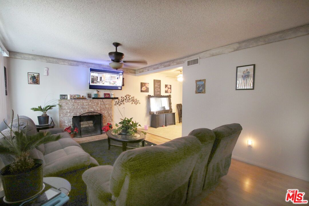 8820 Holly Lane Riverside, CA 92503 - Photo 15 of 20 a living room with furniture a fireplace and a flat screen tv
