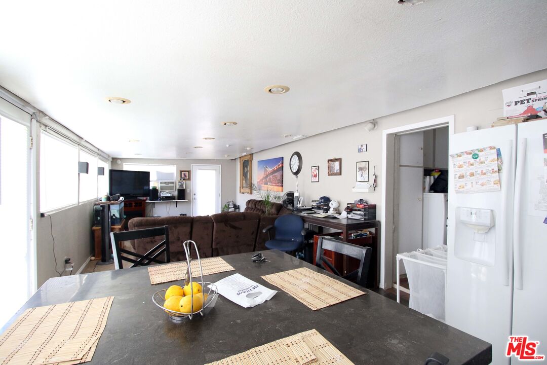 8820 Holly Lane Riverside, CA 92503 - Photo 17 of 20 a living room with furniture and a refrigerator