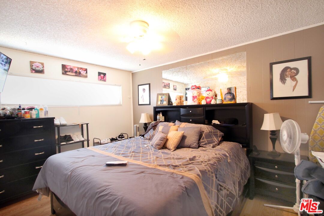 8820 Holly Lane Riverside, CA 92503 - Photo 3 of 20 a bedroom with a bed and a lamp on dresser