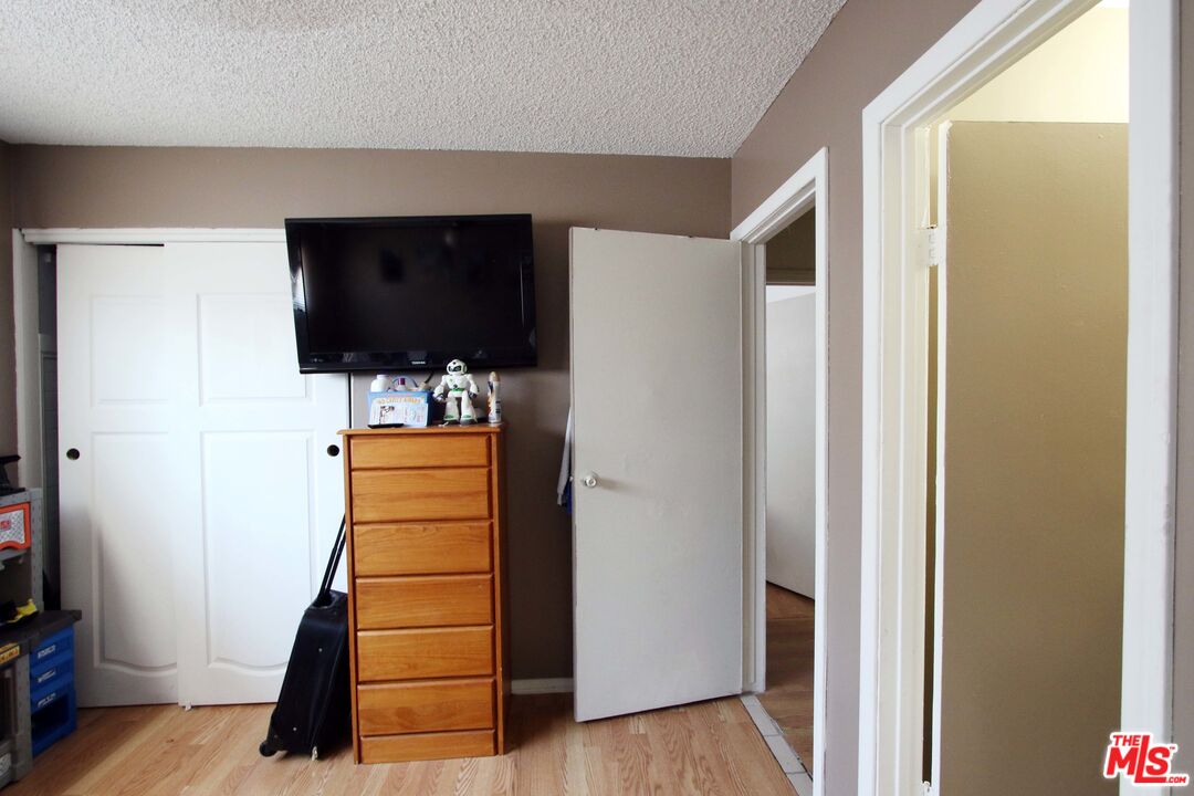 8820 Holly Lane Riverside, CA 92503 - Photo 5 of 20 a view of hallway with stairs and wooden floor
