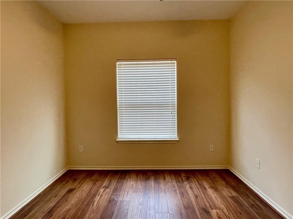 7505 Bell Isle Corpus Christi, TX 78414 - Photo 18 of 24 a view of an empty room with wooden floor and a window