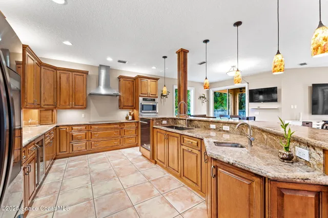 a large kitchen with a large window and stainless steel appliances