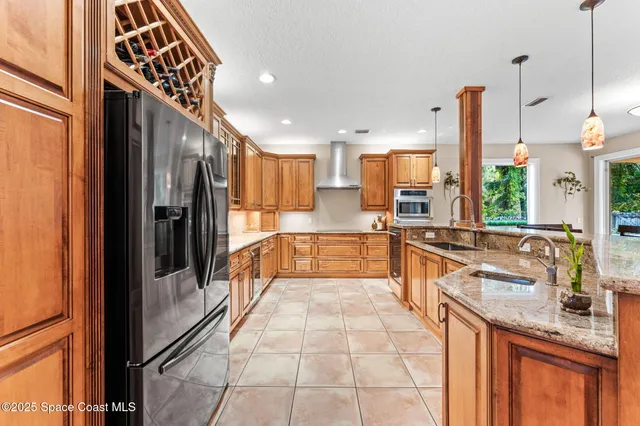 a kitchen with stainless steel appliances granite countertop a refrigerator and cabinets