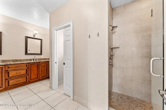 a view of a kitchen with fridge and workspace