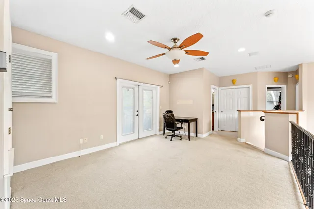 an aerial view of a house with a yard and trees