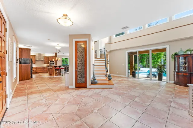 a view of a hallway with windows and lounge chair