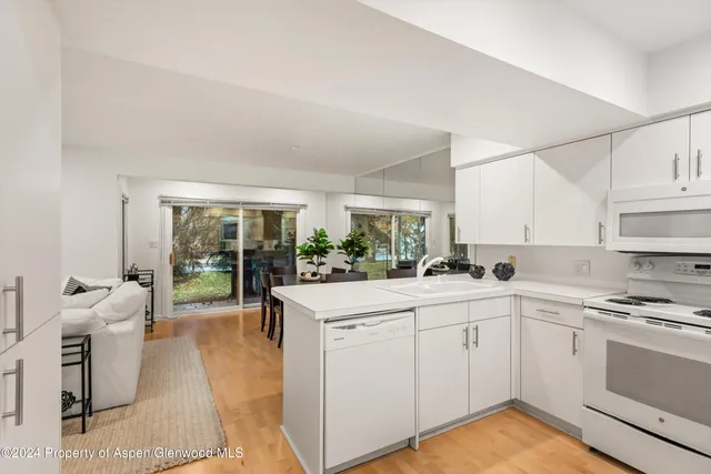 a kitchen with a sink window and cabinets