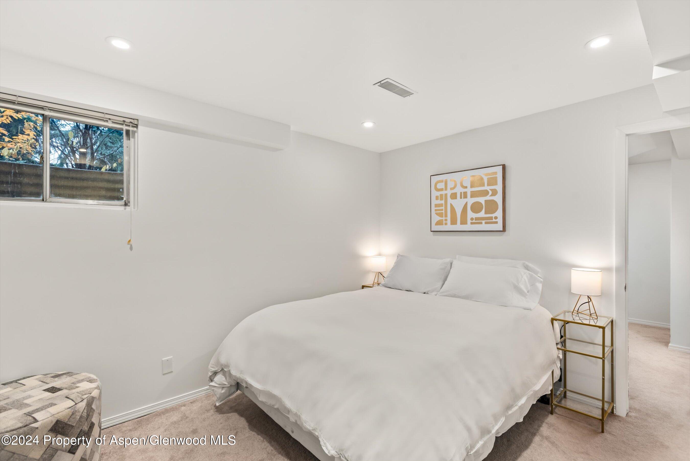 814 West Bleeker Street, Unit D1 Aspen, CO 81611 - Photo 18 of 22 a bedroom with a bed and painting on the wall