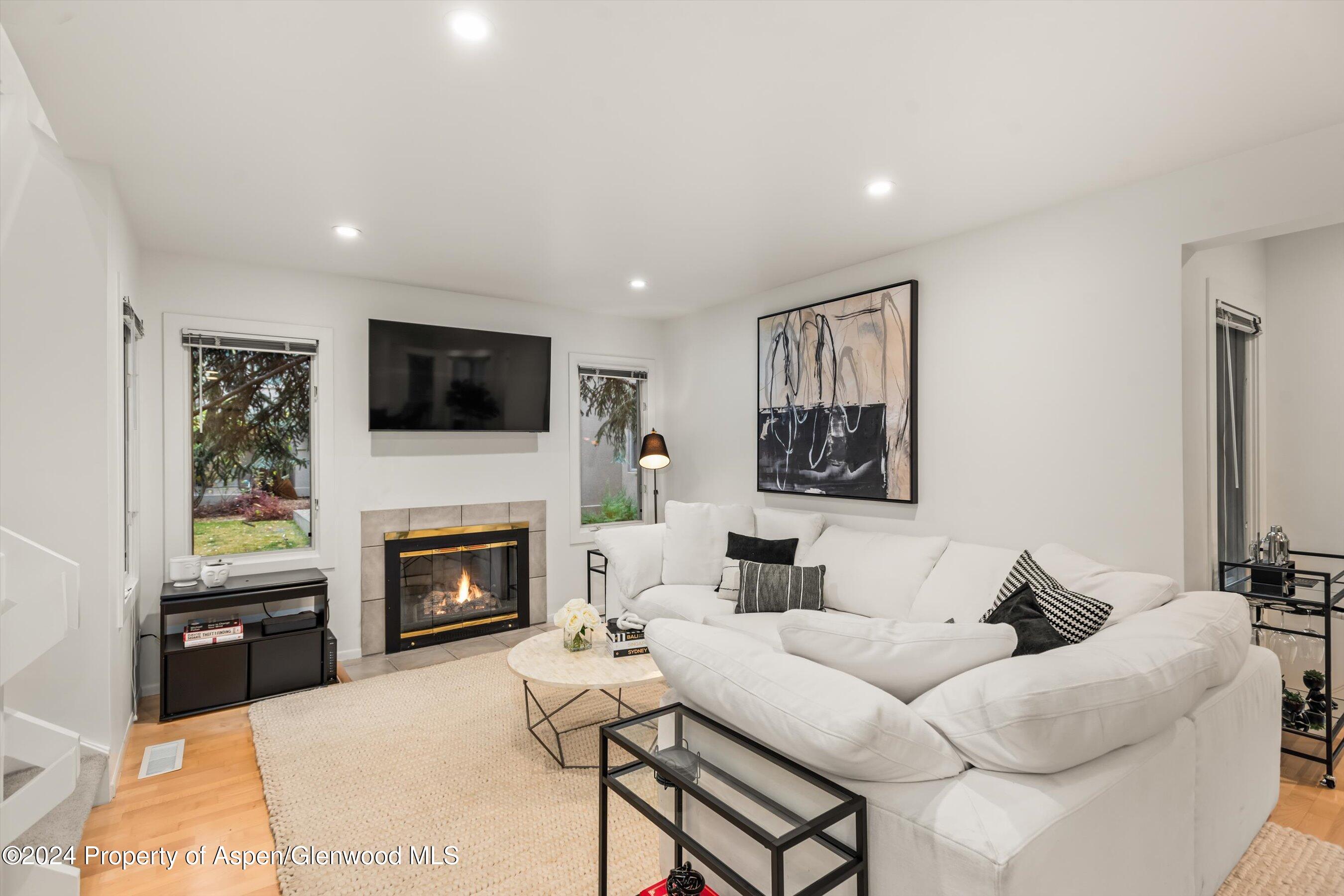 814 West Bleeker Street, Unit D1 Aspen, CO 81611 - Photo 2 of 22 a living room with furniture fireplace and a flat screen tv