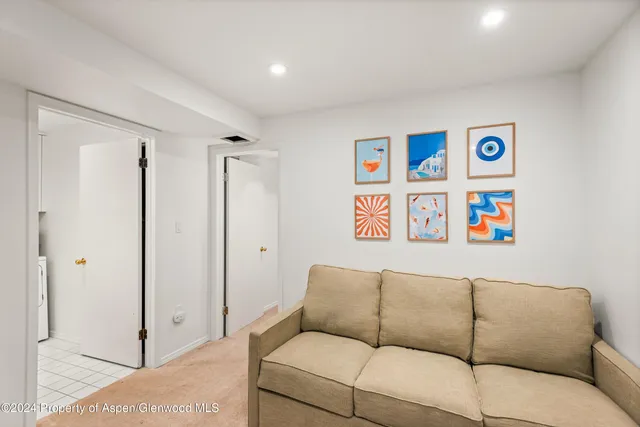 a blue couch sitting next to a bathroom