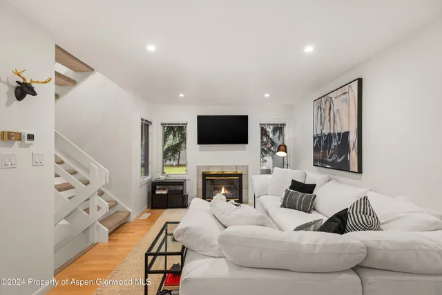 a living room with furniture fireplace and flat screen tv