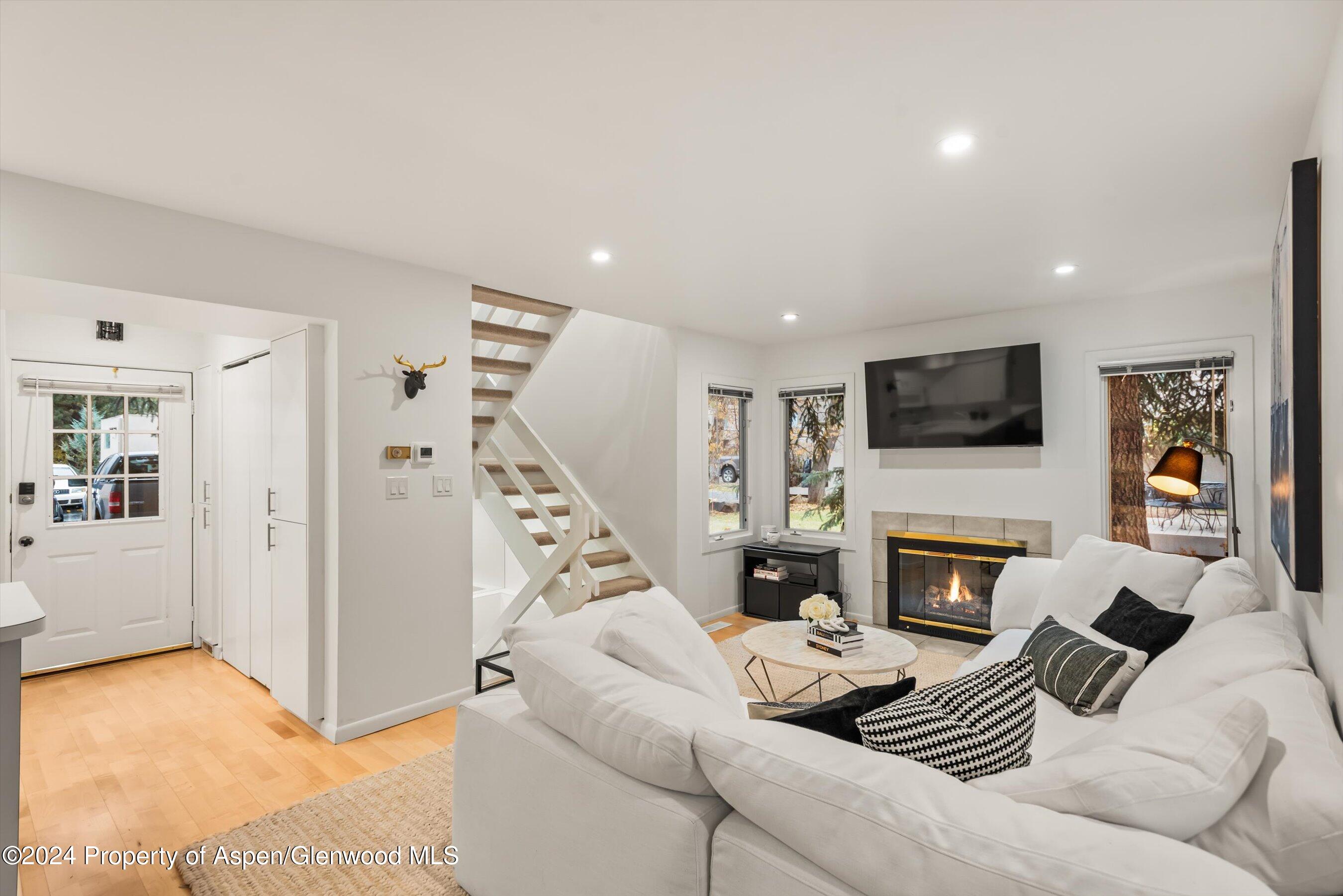 814 West Bleeker Street, Unit D1 Aspen, CO 81611 - Photo 4 of 22 a living room with furniture and a fireplace