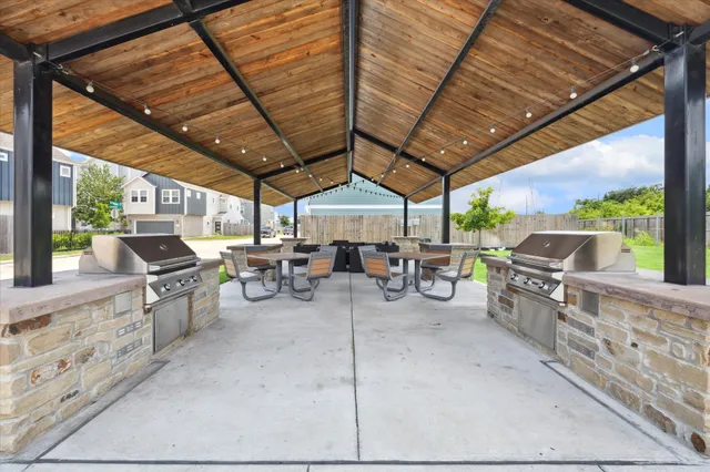 a view of a patio with a table and chairs