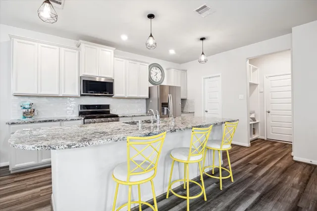 a view of kitchen with sink dining table and chairs