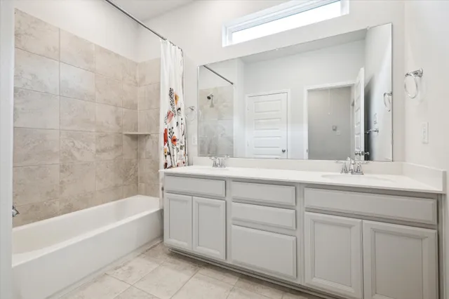 a bathroom with a granite countertop sink mirror and bathtub