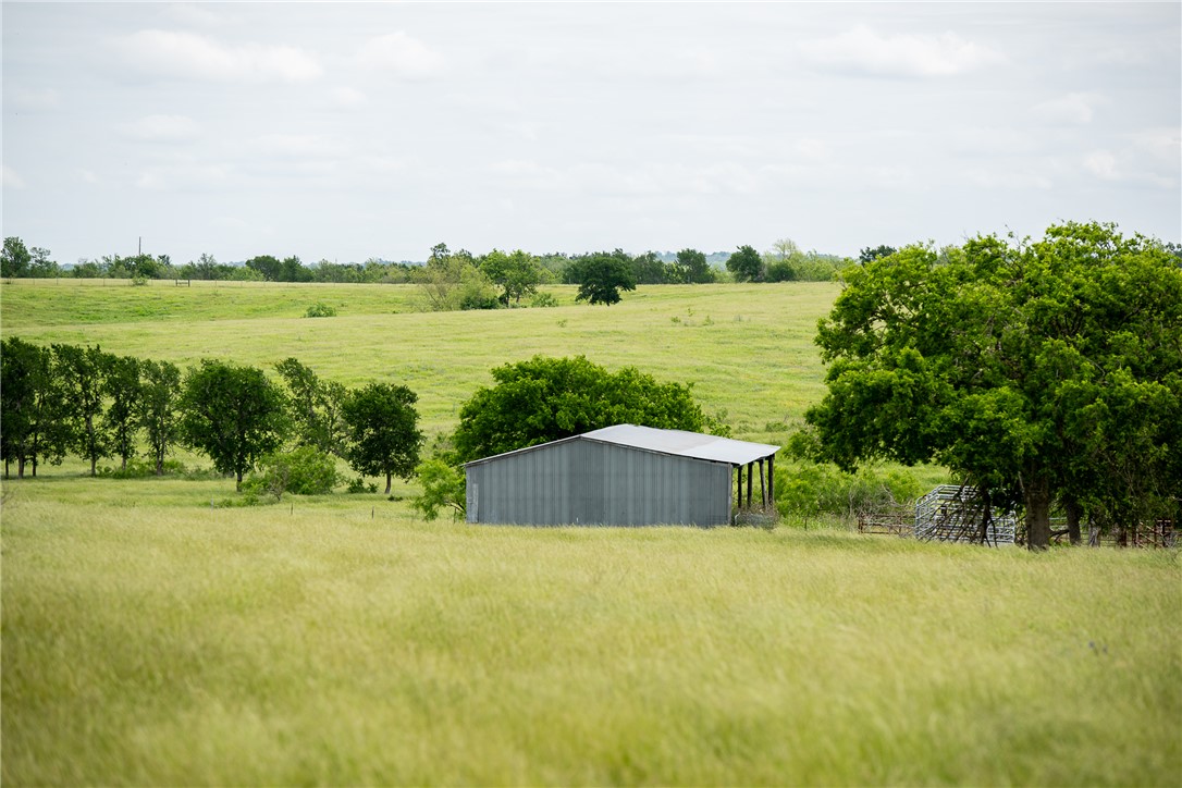 1716 B County Road 469 Coupland, TX 78615 - Photo 4 of 27 View of yard with a view of countryside, a pole building, and an outbuilding