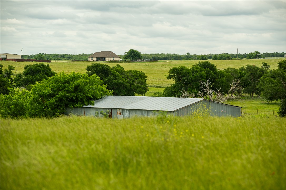 1716 B County Road 469 Coupland, TX 78615 - Photo 5 of 27 View of yard featuring a rural view, a pole building, and an outdoor structure
