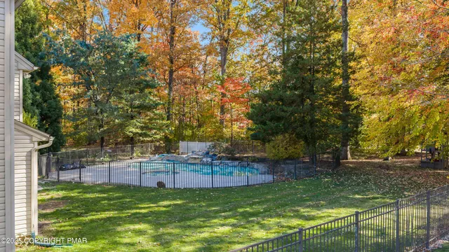 a view of a hallway with wooden floor and windows
