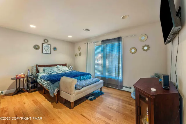 a spacious bathroom with a shower a sink and a mirror