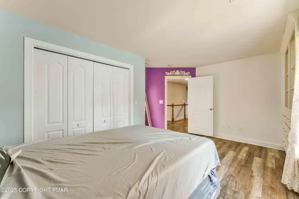 a spacious bathroom with a shower a sink and a mirror