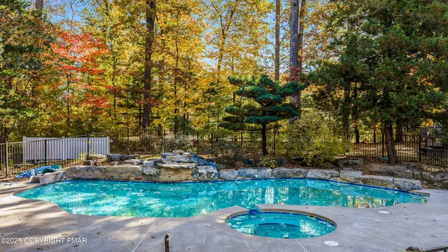 an aerial view of a house with swimming pool and mountain view