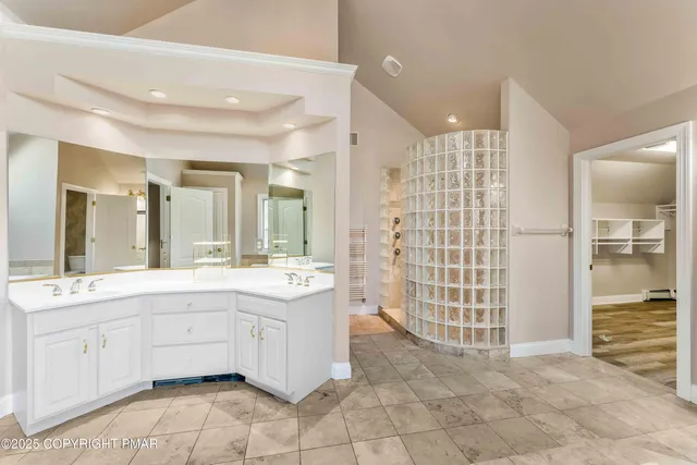 a spacious bedroom with a bed and a couch