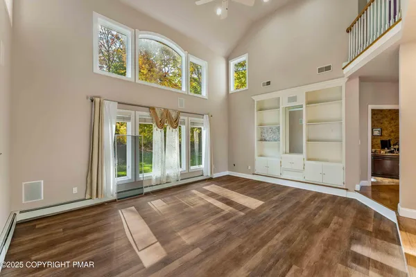 a living room with furniture a dining table and a large window