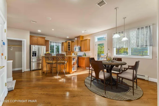 an aerial view of a house with a swimming pool an outdoor seating