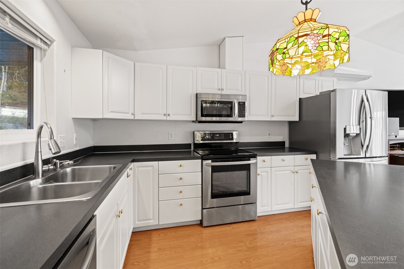 233 Lupine Drive Sequim, WA 98382 - Photo 12 of 40 a kitchen with stainless steel appliances granite countertop a sink stove microwave and refrigerator