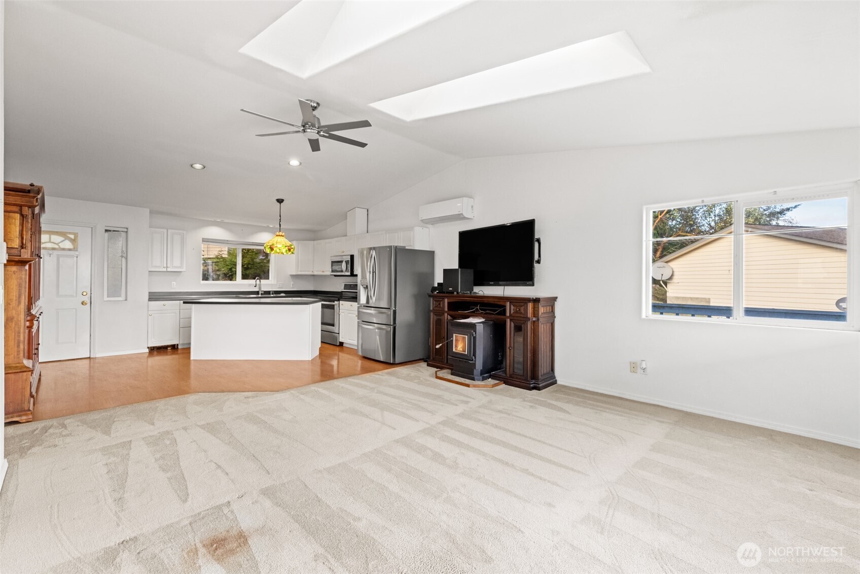 233 Lupine Drive Sequim, WA 98382 - Photo 15 of 40 a large white kitchen with a stove top oven a sink dishwasher and a fireplace