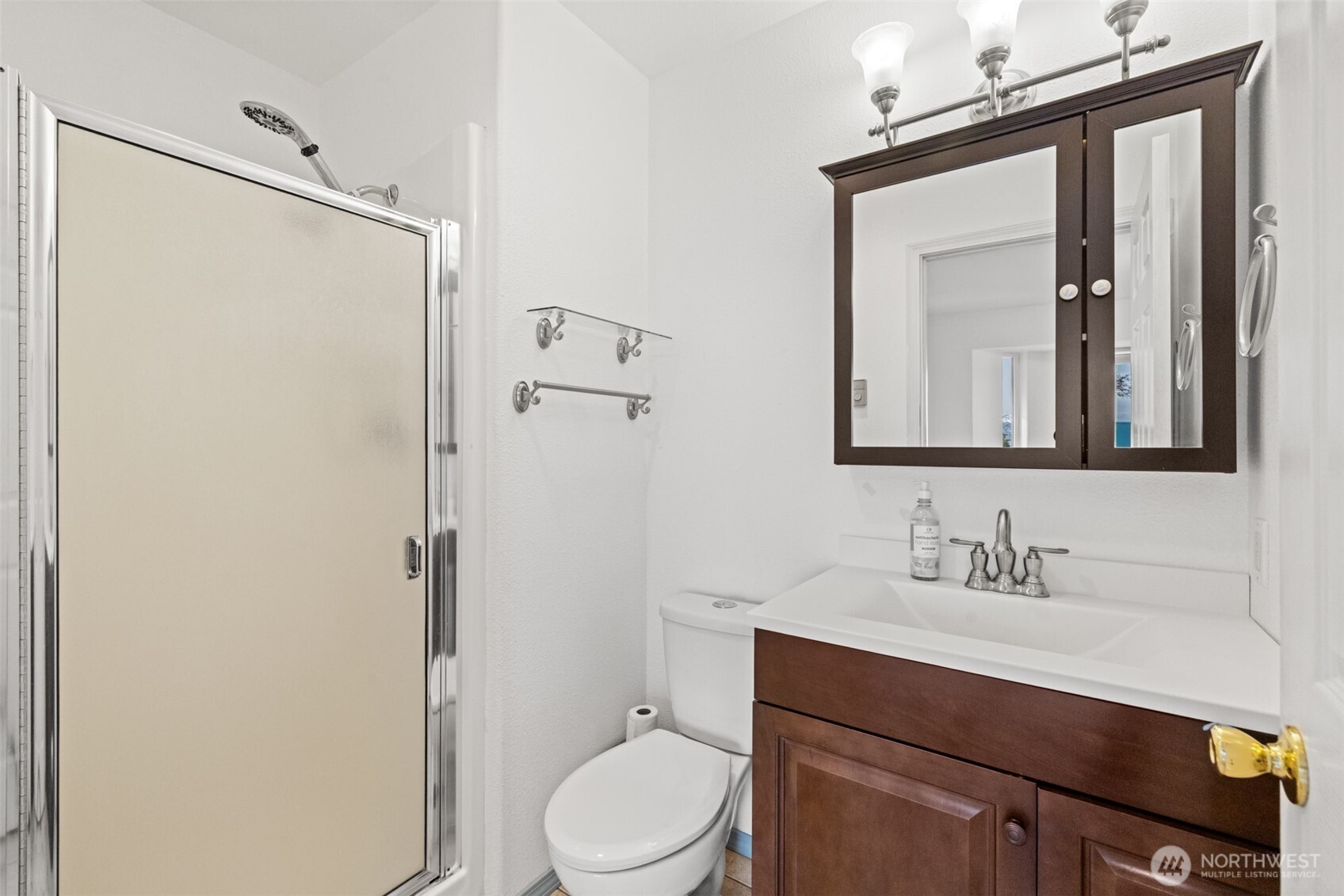 233 Lupine Drive Sequim, WA 98382 - Photo 23 of 40 a bathroom with a toilet a sink a vanity and mirror