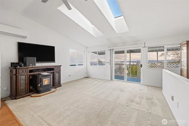 a view of an empty room with a fireplace and a flat screen tv