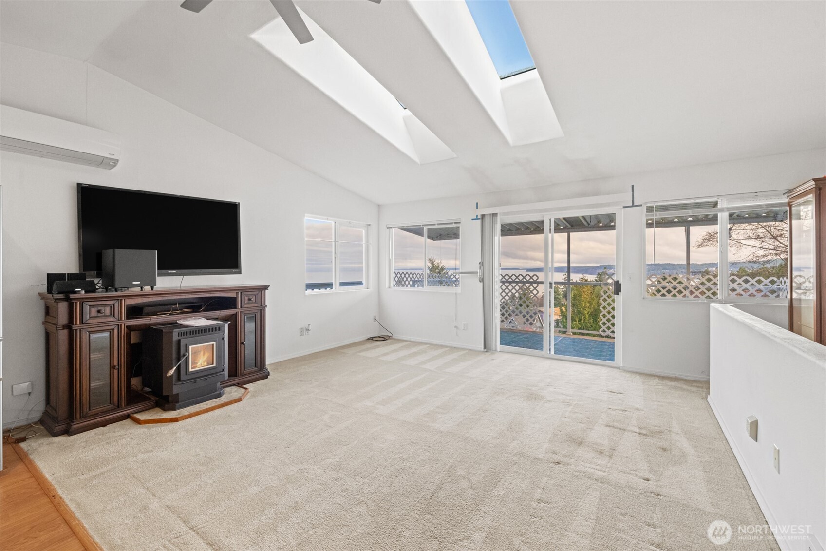 233 Lupine Drive Sequim, WA 98382 - Photo 4 of 40 a view of an empty room with a fireplace and a flat screen tv