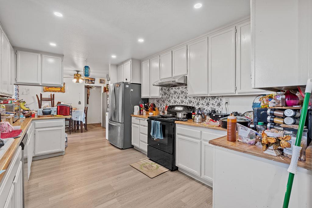 Irwin Lane Santa Rosa, CA 95401 - Photo 32 of 35 a kitchen with refrigerator and cabinets
