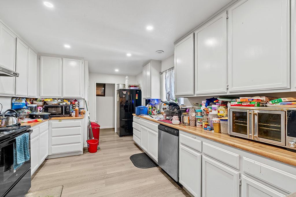 Irwin Lane Santa Rosa, CA 95401 - Photo 34 of 35 a kitchen with stainless steel appliances kitchen island granite countertop a stove and cabinets