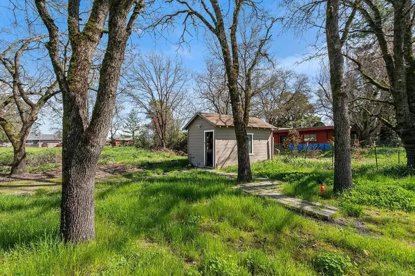 a view of backyard of house with green space